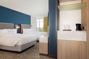 A hotel room with a large bed, a desk with a coffee maker, and a view of the outdoors. - SpringHill Suites by Marriott Ocala (Ocala)