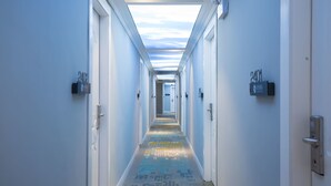 A long, narrow hotel corridor with a skylight ceiling, doors numbered 2401 and 2402, and a colorful carpet. - Sucha Hotel Chongqing Jiefangbei (Chongqing)