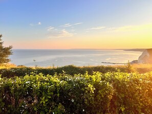 A coastal landscape with a view of the sea and cliffs.