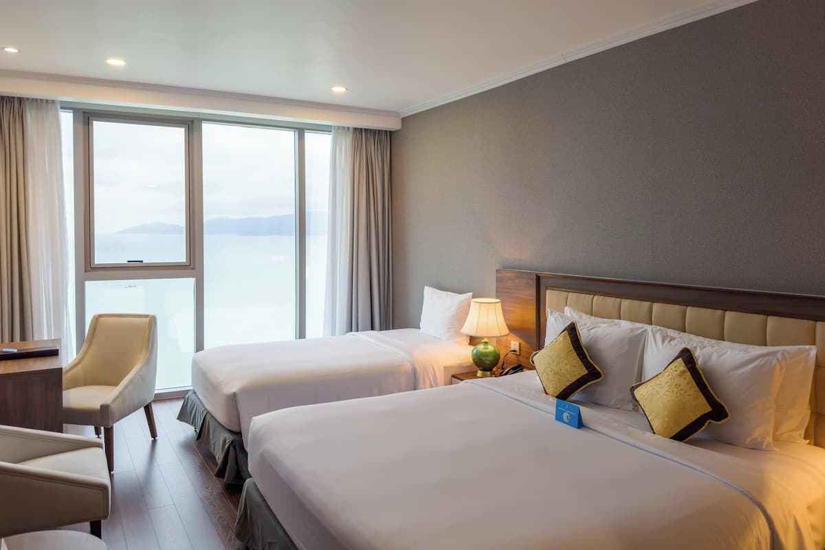 Deluxe Triple Room, Ocean View | Minibar, in-room safe, soundproofing, iron/ironing board