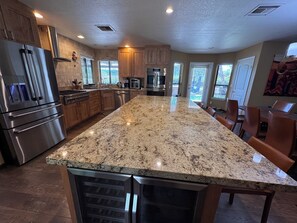 A spacious kitchen with granite countertops, stainless steel appliances, and wooden cabinets. - Fabulous Sedona Sanctuary (Sedona)