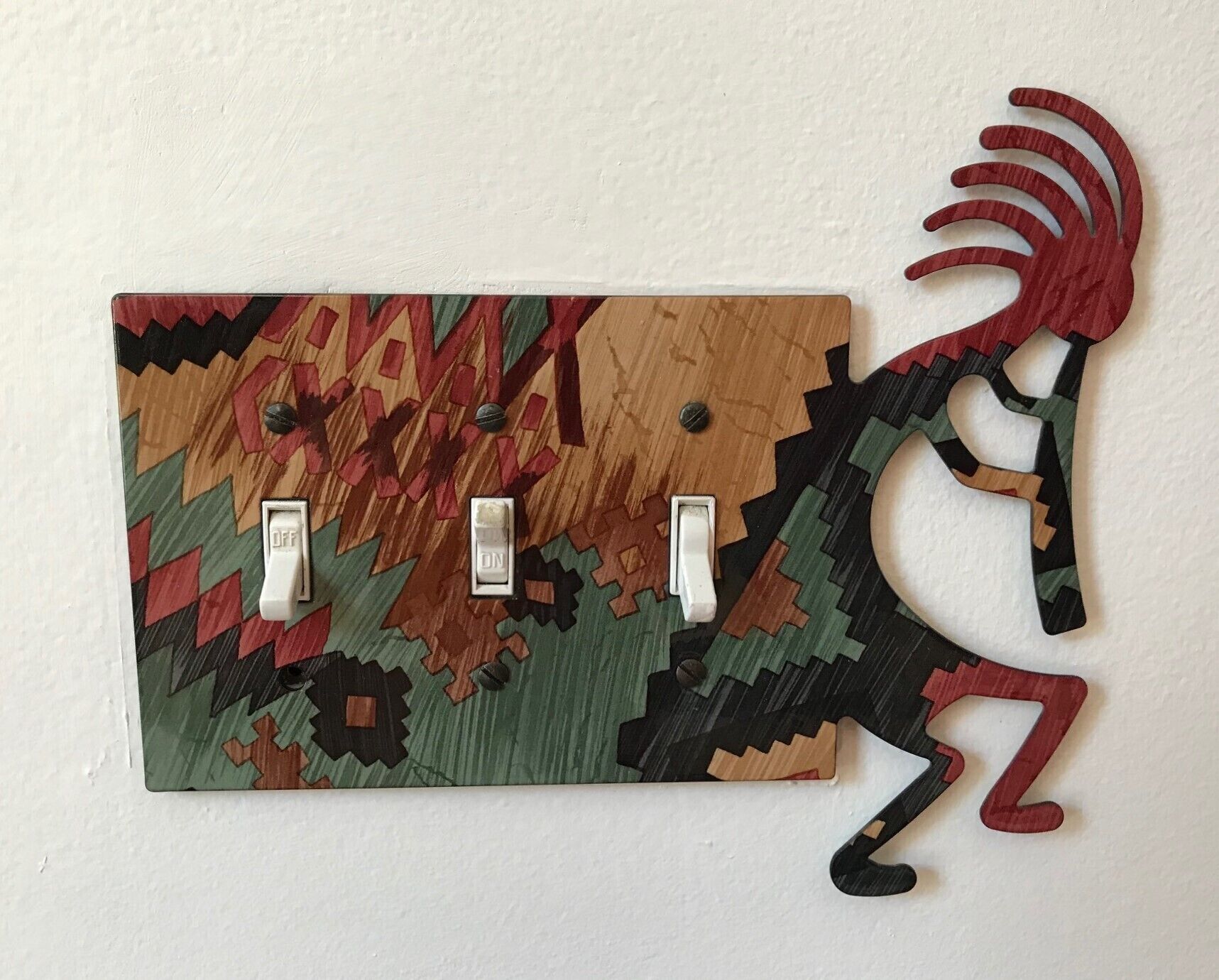 A wall-mounted light switch with a decorative animal design.