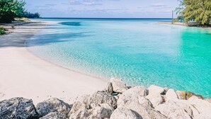 A beach with clear turquoise water, white sand, and rocky outcrops. - Paradise Found,GREAT LOCATION,free golfcart, dishwasher, sup, kayak, rain water  (Spanish Wells)