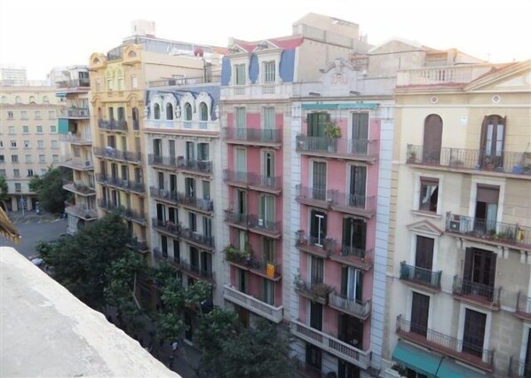 A multi-story building with balconies and a central courtyard.