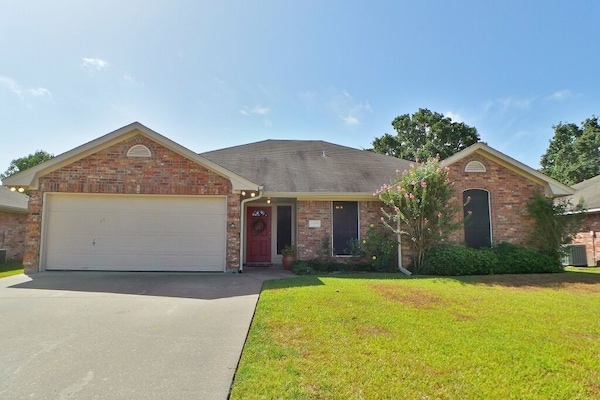 Home exterior with parking for 4 cars in driveway and garage.