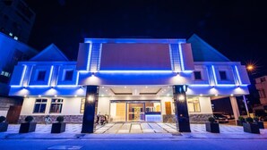 A hotel with a modern facade, large entrance, and illuminated blue lighting. - Dongdaemun Boutique Hotel (Hualien City)