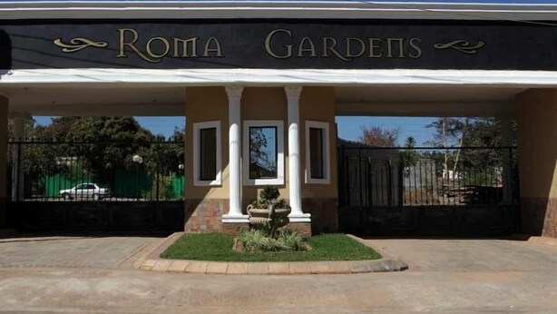 A building entrance with the sign "Roma Gardens". - Roma Gardens (Lusaka)