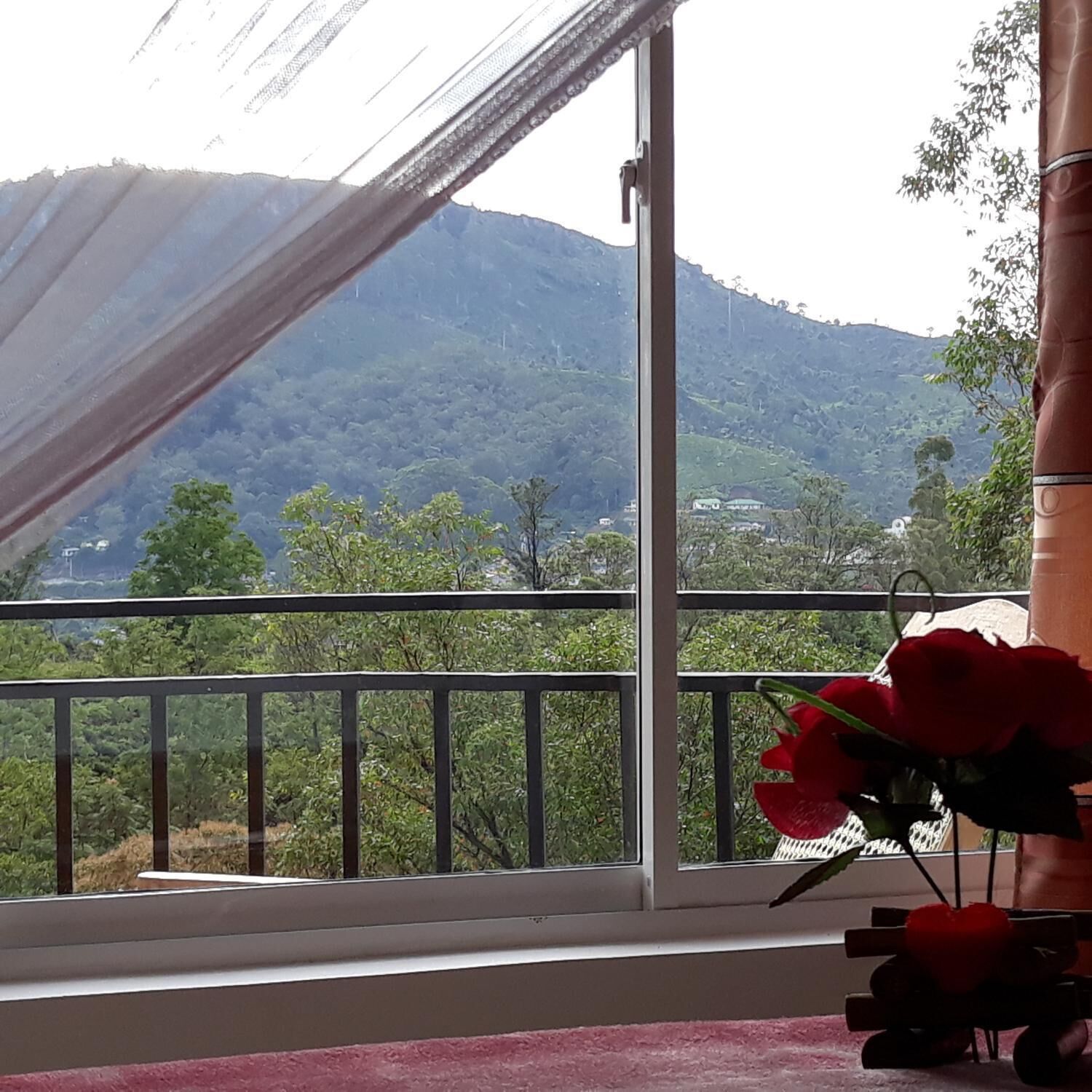 A balcony with a view of a mountainous landscape.