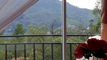 A balcony with a view of a mountainous landscape.