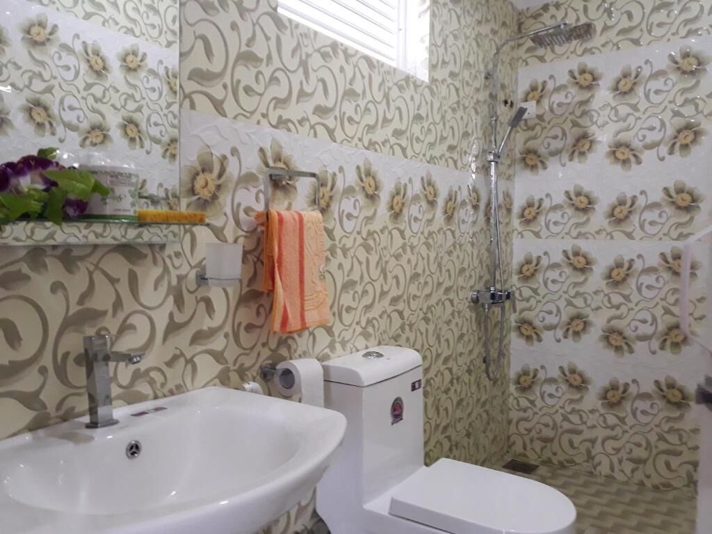 A bathroom with a sink, toilet, and shower.
