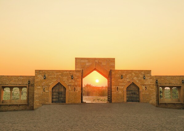 A historic building with a large archway and multiple arched windows.