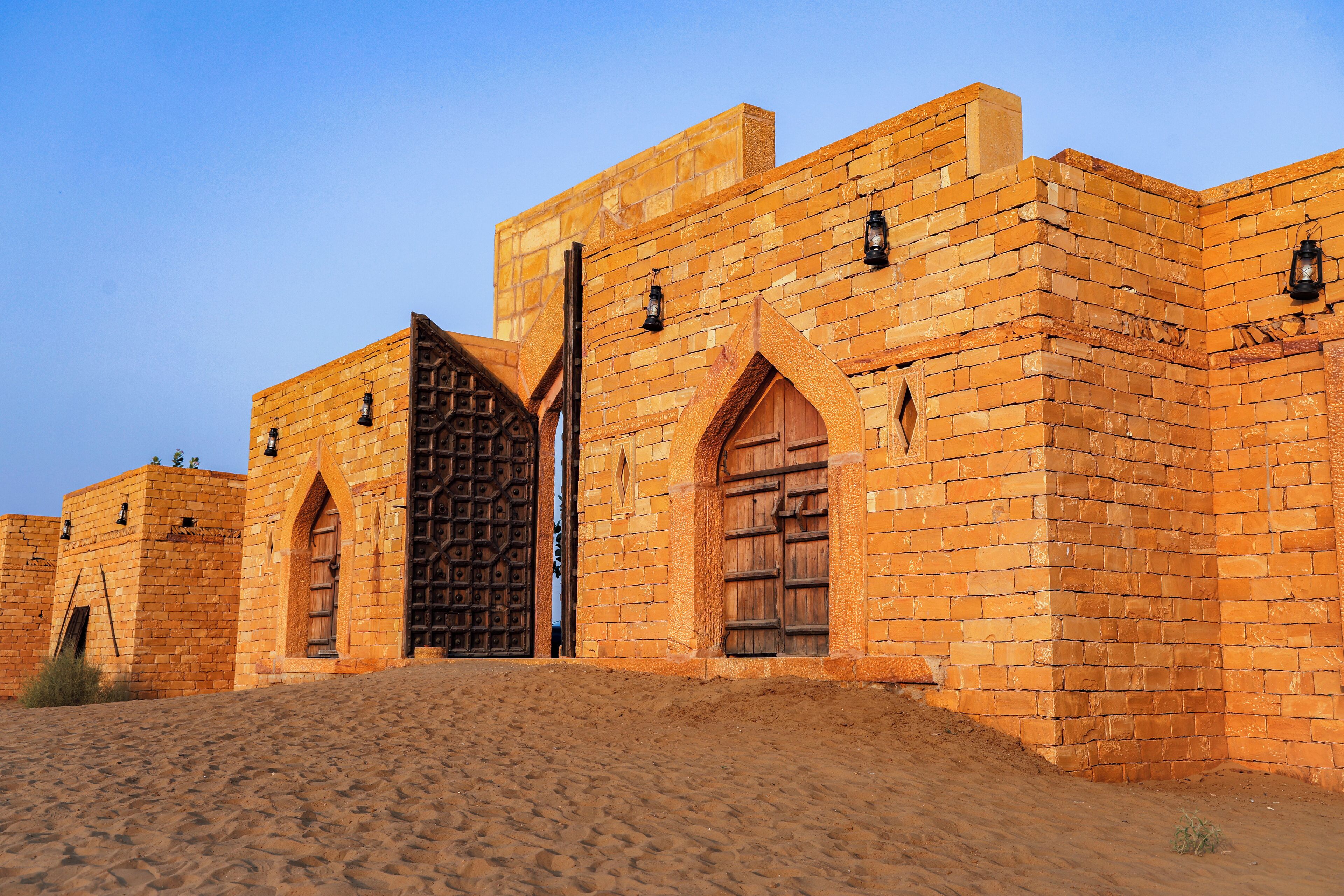 A historic building with arched doorways and a prominent gate.