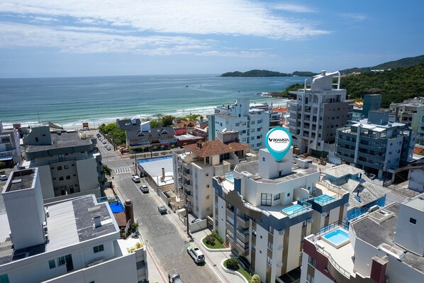 A coastal urban area with modern buildings, a clear view of the sea, and a prominent Boavista logo.