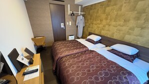 A hotel room with two beds, a desk with a computer and phone, a chair, and a wardrobe. - Comfort Stay Miyabi (Chichibu)