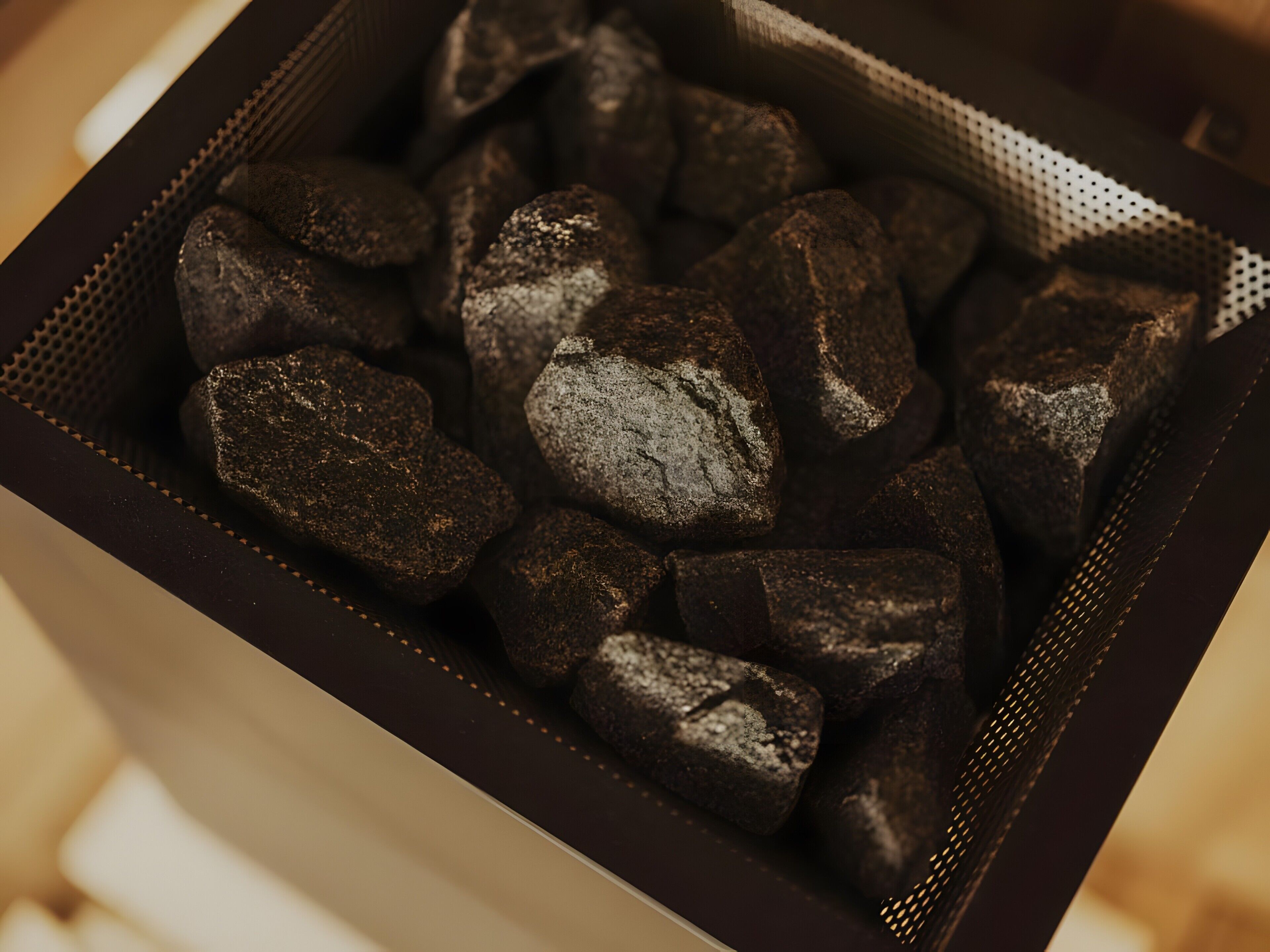 A box containing dark-colored, irregularly shaped objects.