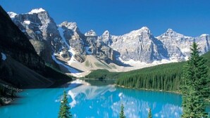 A mountain landscape with a clear lake reflecting the peaks. - Suite With Private Entrance 20 min to YYC Airport (Airdrie, Canada)