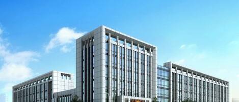 A modern building with a rectangular shape, multiple floors, and a flat roof.