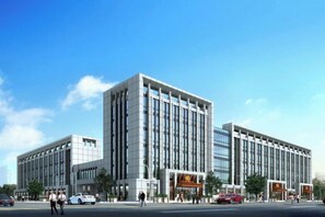 A modern building with a rectangular shape, multiple floors, and a flat roof. - Zhoucun Shaobing Hotel (Zibo)
