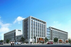Un edificio moderno de forma rectangular, con varios pisos y techo plano.