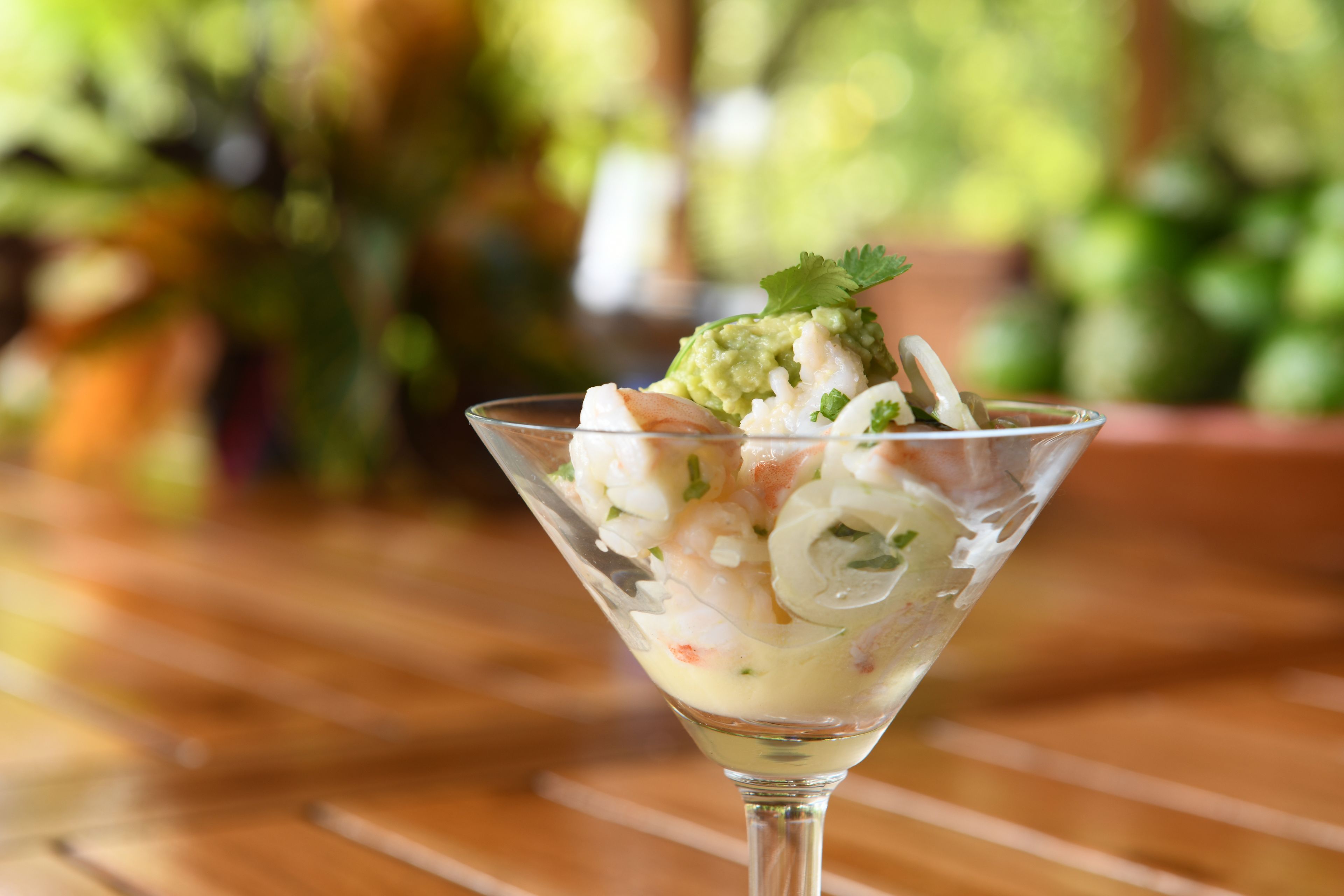 A cocktail in a glass with a garnish on top.