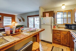 A kitchen with a wooden island, a refrigerator, and a microwave. - Cozy Angel Fire Condo < Half Mi to Resort! (Angel Fire)