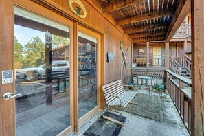 A wooden building with a glass door, a bench, and skis leaning against the wall. - Cozy Angel Fire Condo < Half Mi to Resort! (Angel Fire)
