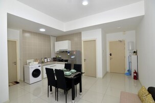 A compact apartment with a kitchen, dining area, and a living space.