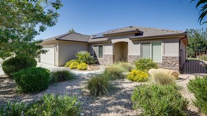 A two-story house with a stone facade, a tiled roof, and a gravel driveway. - Private Pool, Mtn Views! Hurricane Group Getaway (Hurricane)