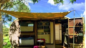 A compact, mobile living space with a sleeping area, storage compartments, and a small kitchenette. - IDestinos Tayrona mobile home  (La Poza)