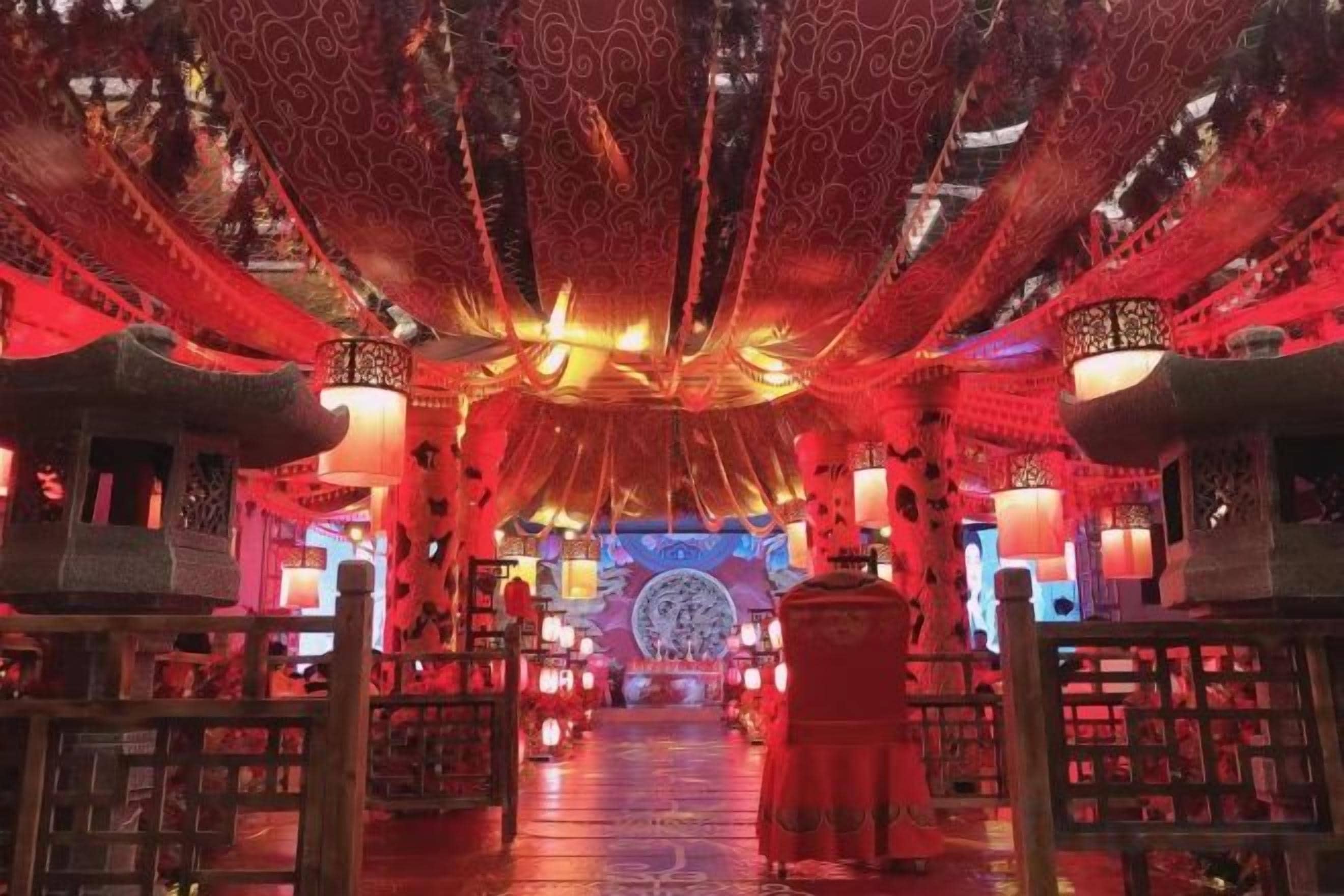 An interior with a central aisle, traditional decor, and a patterned ceiling.