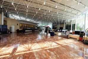 A spacious lobby with a high ceiling, marble flooring, and a reception desk. - Huaian Hotel (Huai'an)