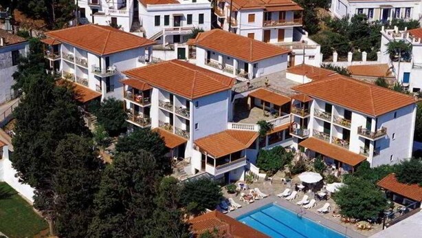 A residential area with multiple two-story houses, a swimming pool, and a small garden area. - Ionia (Skopelos)