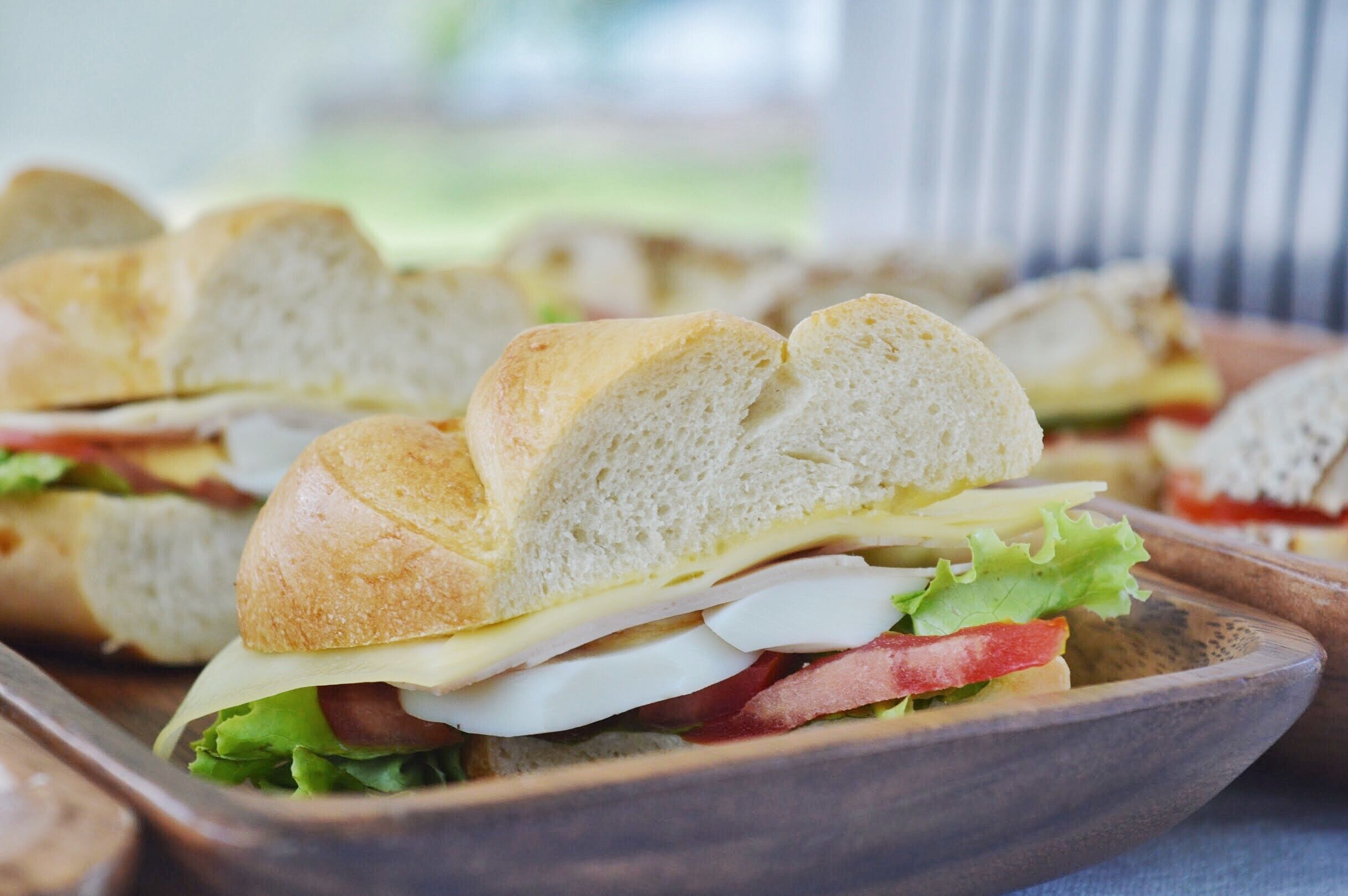 A close-up of sandwiches with visible ingredients like lettuce, tomato, and cheese.