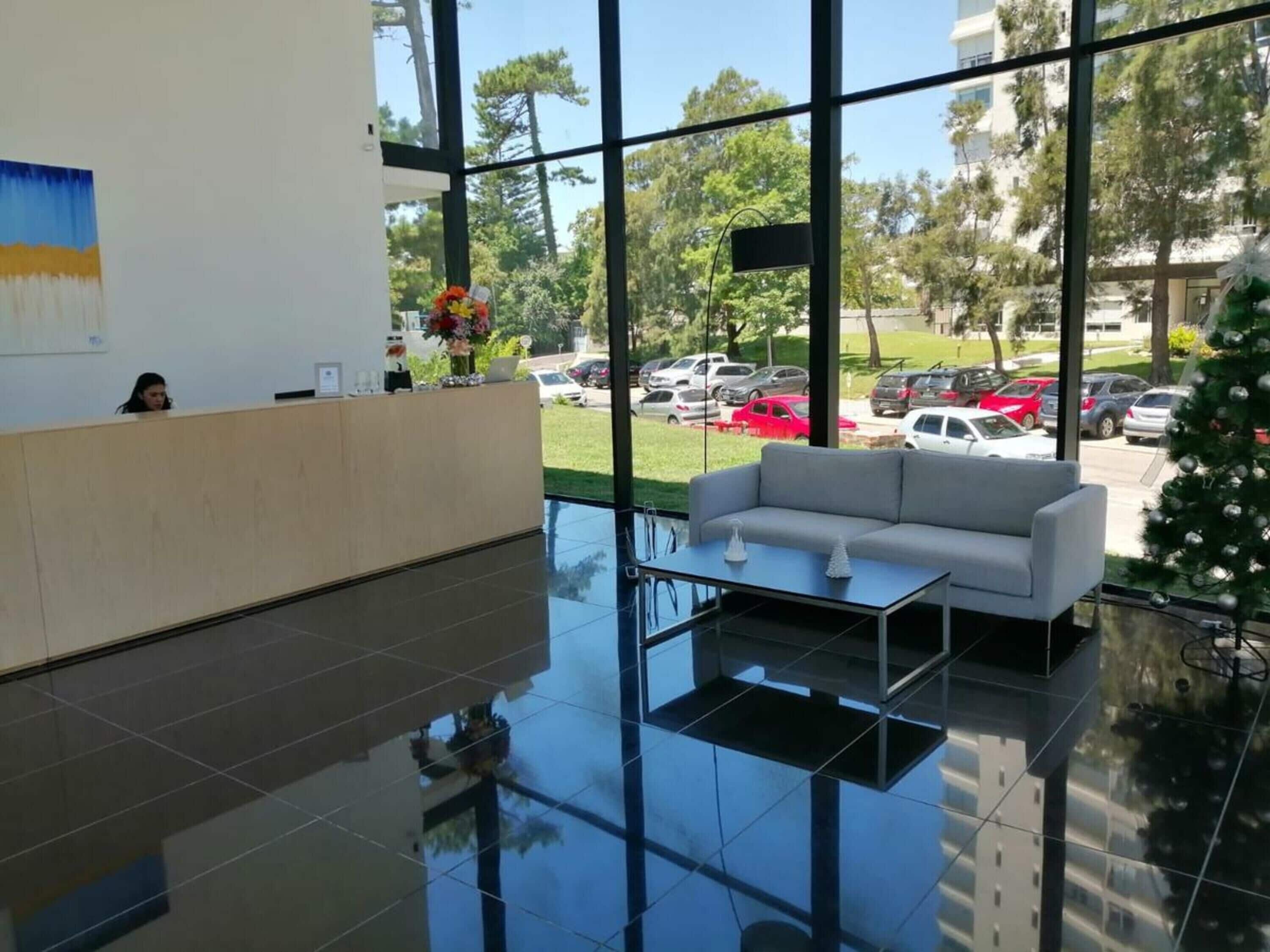 A reception area with a reception desk, a sofa, and a coffee table.