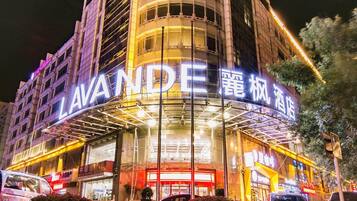 A multi-story building with a prominent 'LAVANDE' sign, featuring a modern architectural design with a glass facade and illuminated signage.