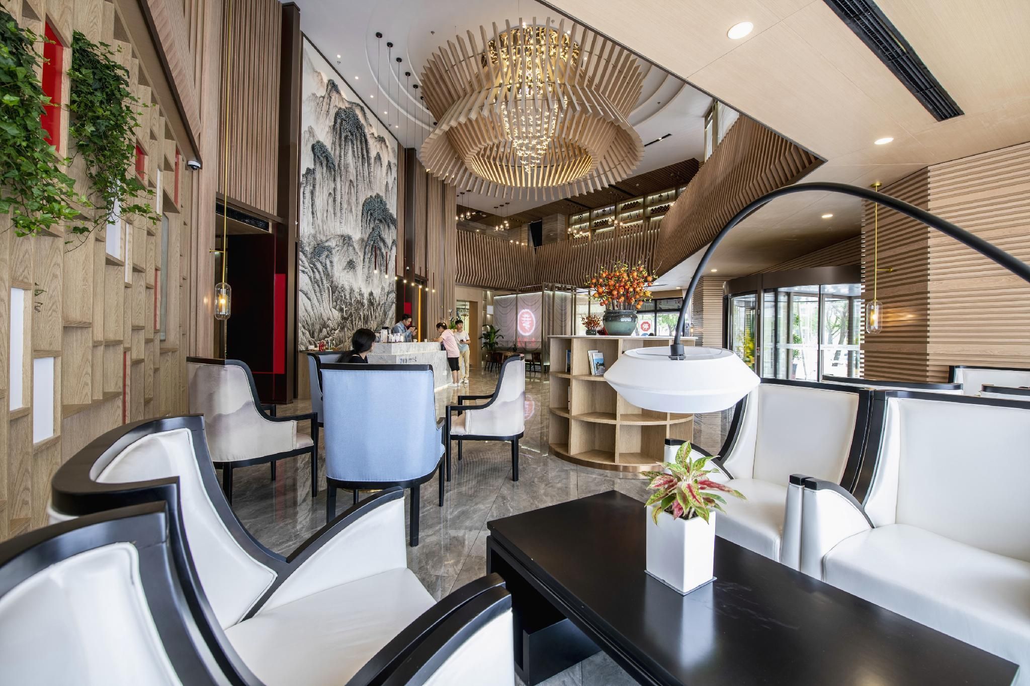 A modern interior with a reception desk, seating area, and a large decorative wall.