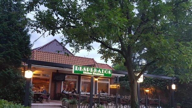 A restaurant named 'DESPERADOS' with outdoor seating and a garden area. - Desperados Hotel (Bergen)