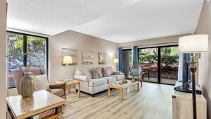A spacious living room with a sofa, coffee table, and decorative lamps. - Coastal Comfort Escape Close to Beach & Eats (Hilton Head Island)