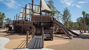 A pirate-themed play structure with a slide, climbing area, and a ship-like roof. - Coastal Comfort Escape Close to Beach & Eats (Hilton Head Island)
