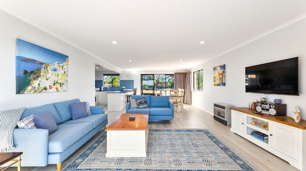 A modern living room with a sofa, coffee table, and a TV.