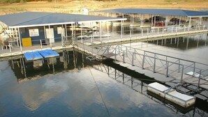 A marina with a dock, a covered building labeled "Island Marina," and a calm water body. - Luxury Condo on its Own Private Island on Lake Travis (Lago Vista)