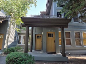 A building with a covered entrance, two doors, and a small porch area. - Snowcreek Resort Vacation Rental 871 (Mammoth Lakes)
