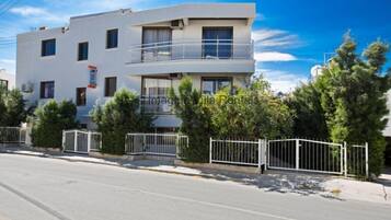 A modern two-story building with a balcony on the upper floor.