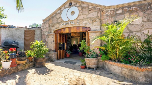 A stone building with a wooden entrance labeled "Capital O". - Collection O Posada Terraza (Tequila)