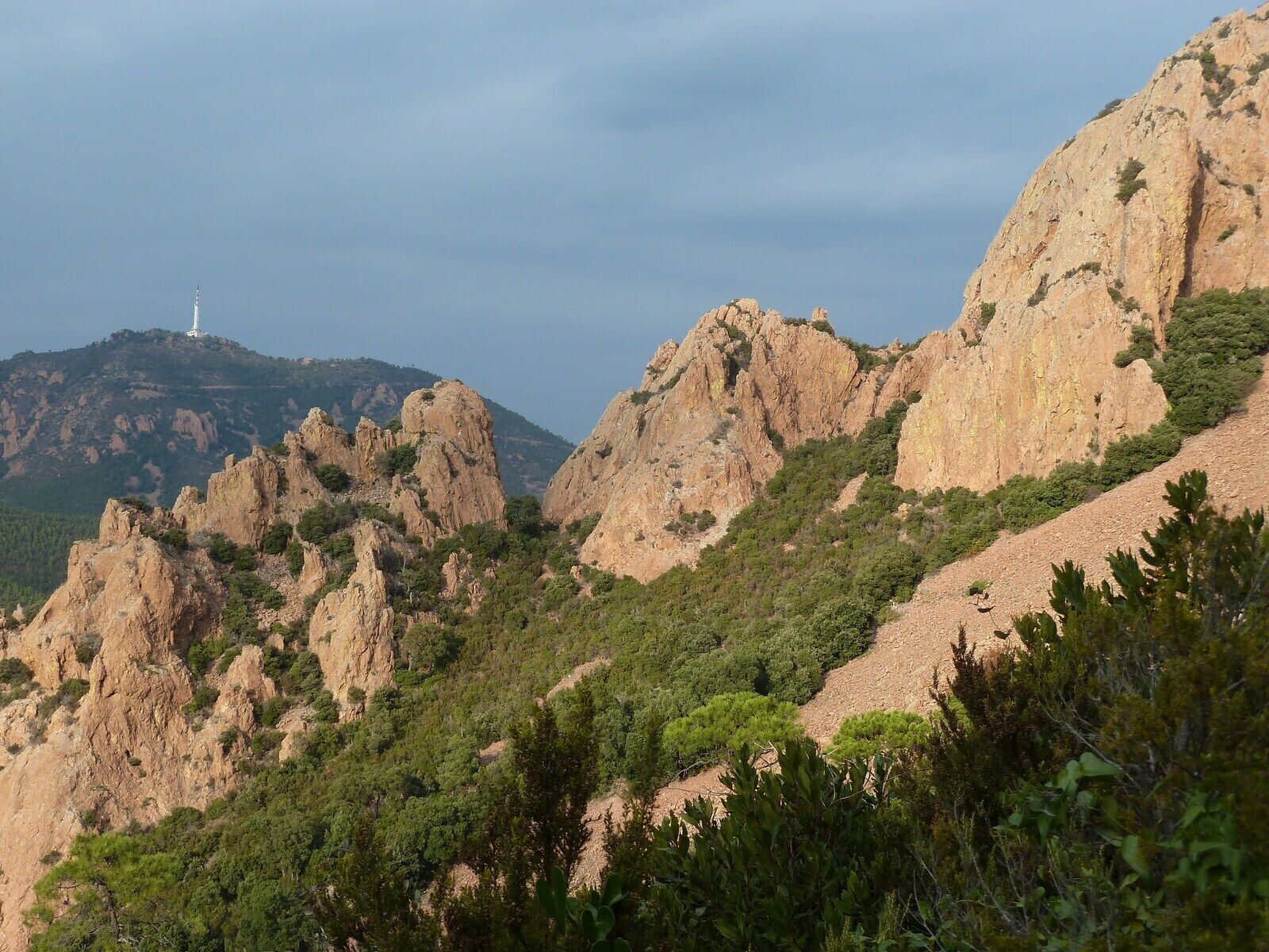 A mountainous landscape with rocky terrain and sparse vegetation.