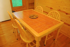 Enjoy meals in this dining area with a rectangular table and comfortable chairs.