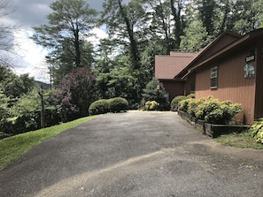 Step into the serene surroundings of Brantwood, where a traditional building awaits amidst lush greenery and a well-maintained landscape.