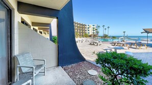 A hotel balcony with a view of a pool and beach. - Oceanfront - Poolside - Steps to Beach & Tiki Bar (Daytona Beach Shores)