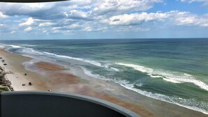 A beach with waves, a clear sky, and a concrete structure. - Luxury Ocean Front 2br/2ba Horizons Condo17th Floor - Awesome views (Daytona Beach)