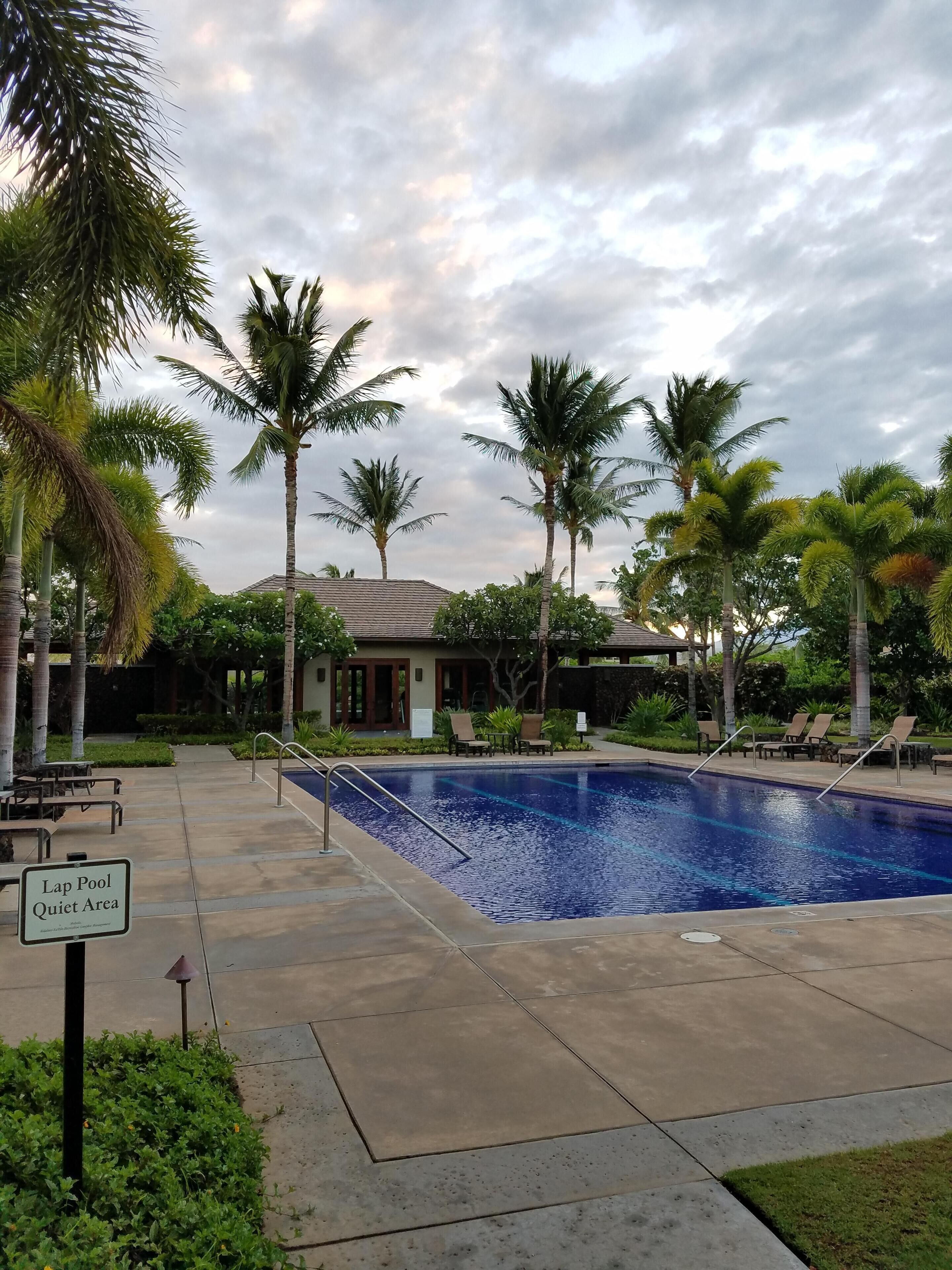 A lap pool with lounge chairs and a sign indicating it is a quiet area.
